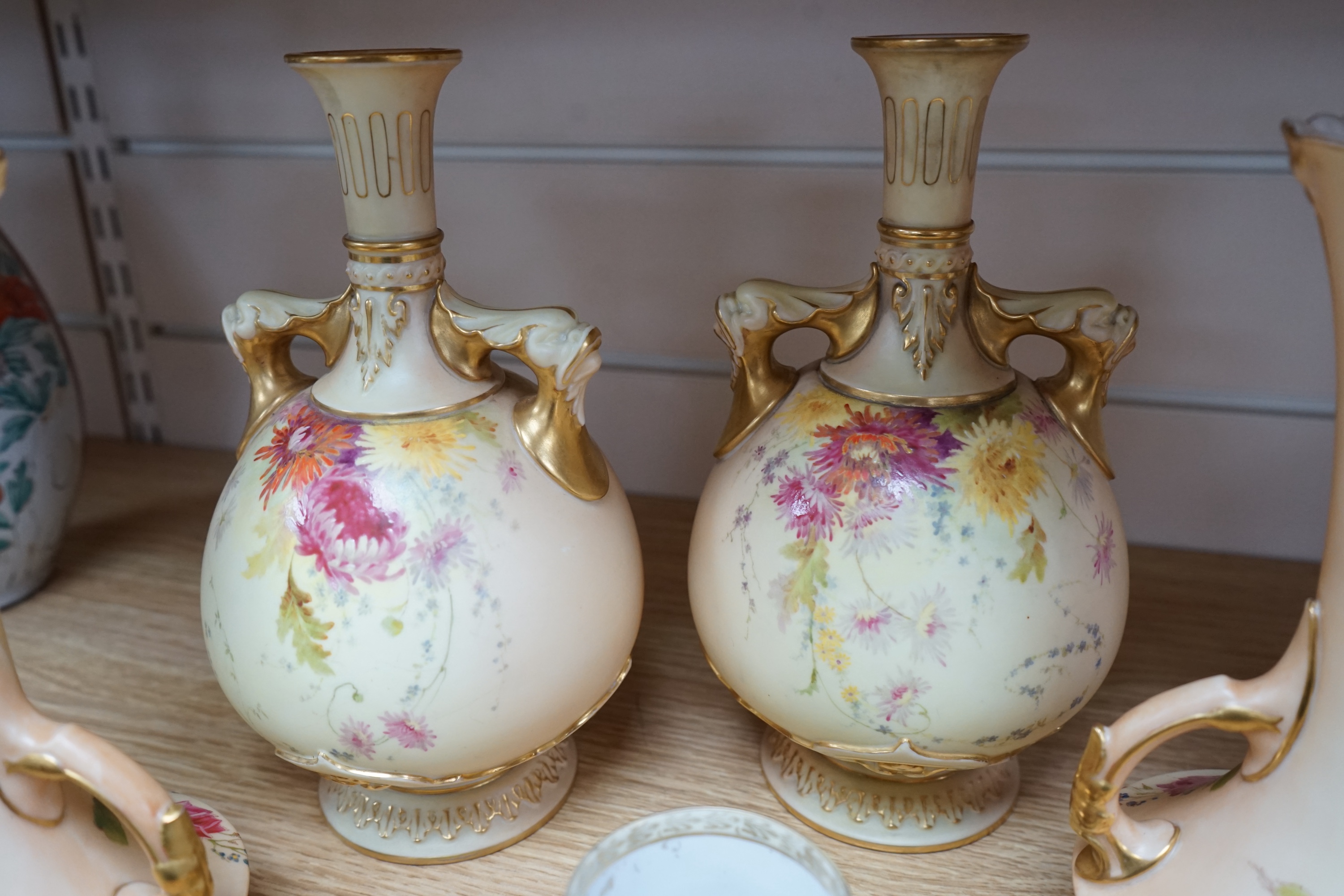 Two pairs of Royal Worcester blush ivory vases, model numbers 2332 and 1626 and Vienna type coffee can with saucer, tallest 22cm. Condition - good